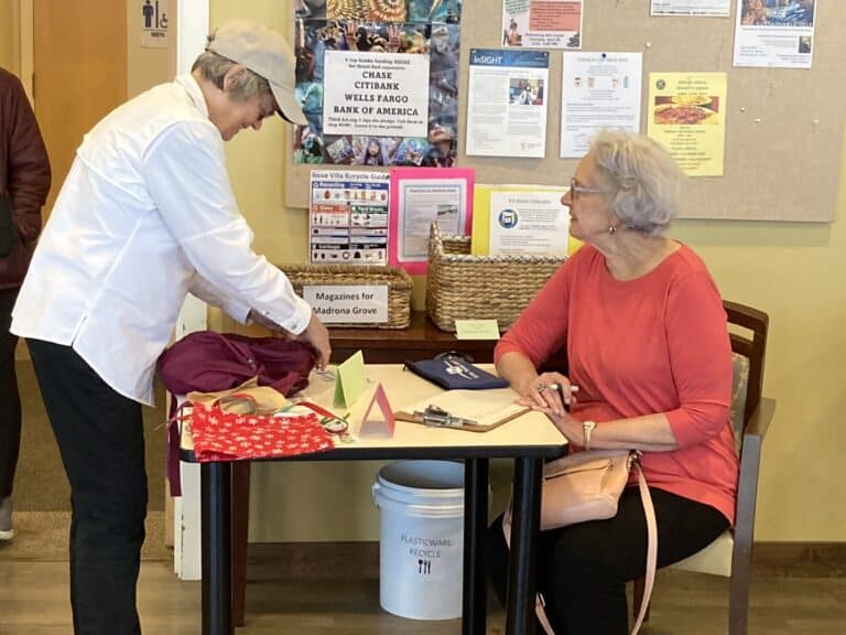 Linda Burke making a donation with Miranda Manners