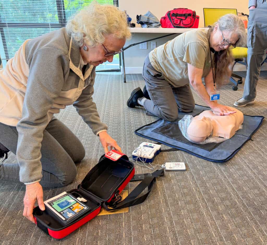 Jude Watson and Louise Williams practicing CPR