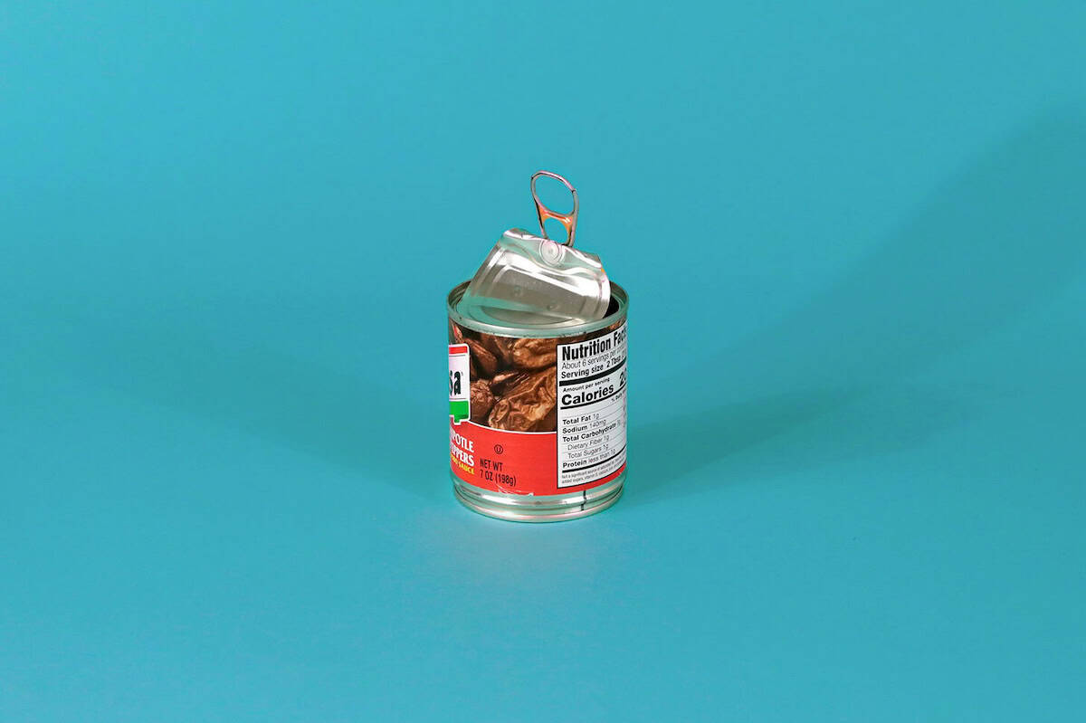 Metal can with lid attached