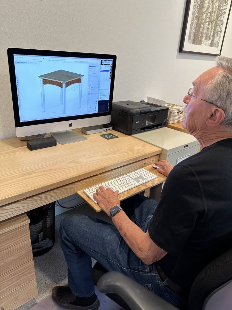 Don working on a design, desk in ash