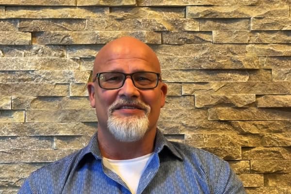 Bald man with glasses and a goatee